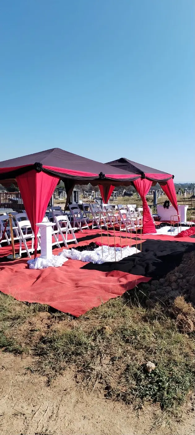 A red and white outdoor funeral ceremony arrangement prepared by BNN